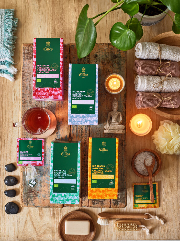 Eilles Tea's organic spa range featuring colourful boxes, tea, candles, and spa accessories for relaxing wellness rituals.