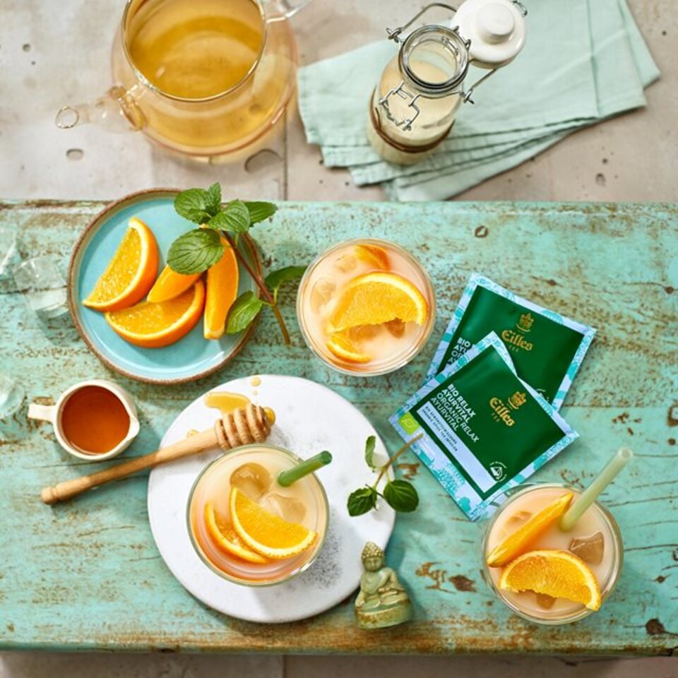 Erfrischender Eilles-Eistee mit Orangenscheiben, Minze und Honig, perfekt für einen entspannten Nachmittag.